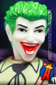Fully artciulated Retro-Action Joker action figure with authentic fabric outfit.